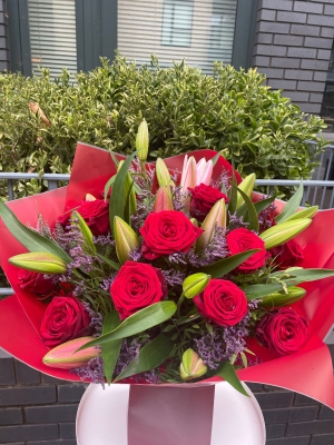 Red roses, limonium and lilies bouquet